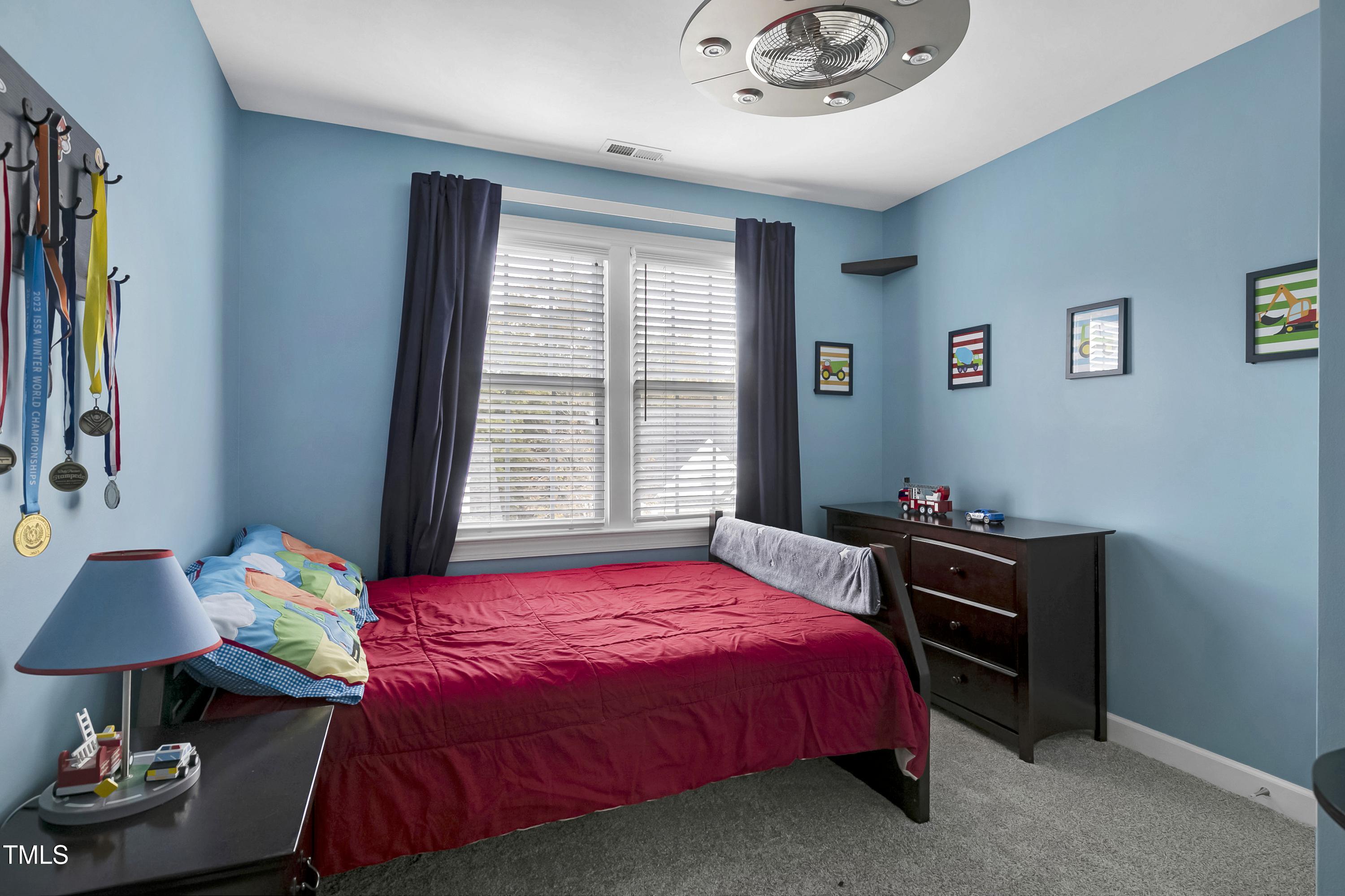 102 Kenneil Court Apex, NC 27502 - Photo 26 of 55 a bedroom with a bed and a table in it