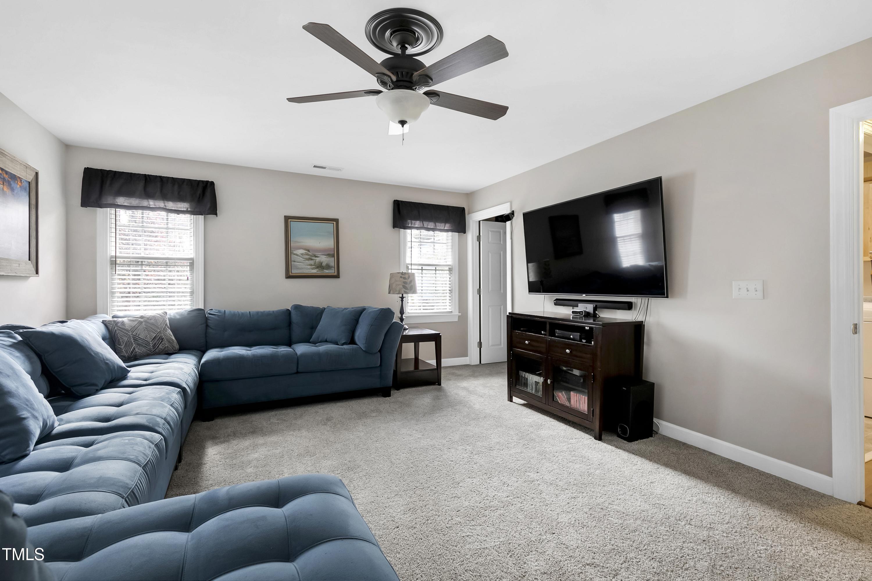 102 Kenneil Court Apex, NC 27502 - Photo 28 of 55 a living room with furniture and a flat screen tv