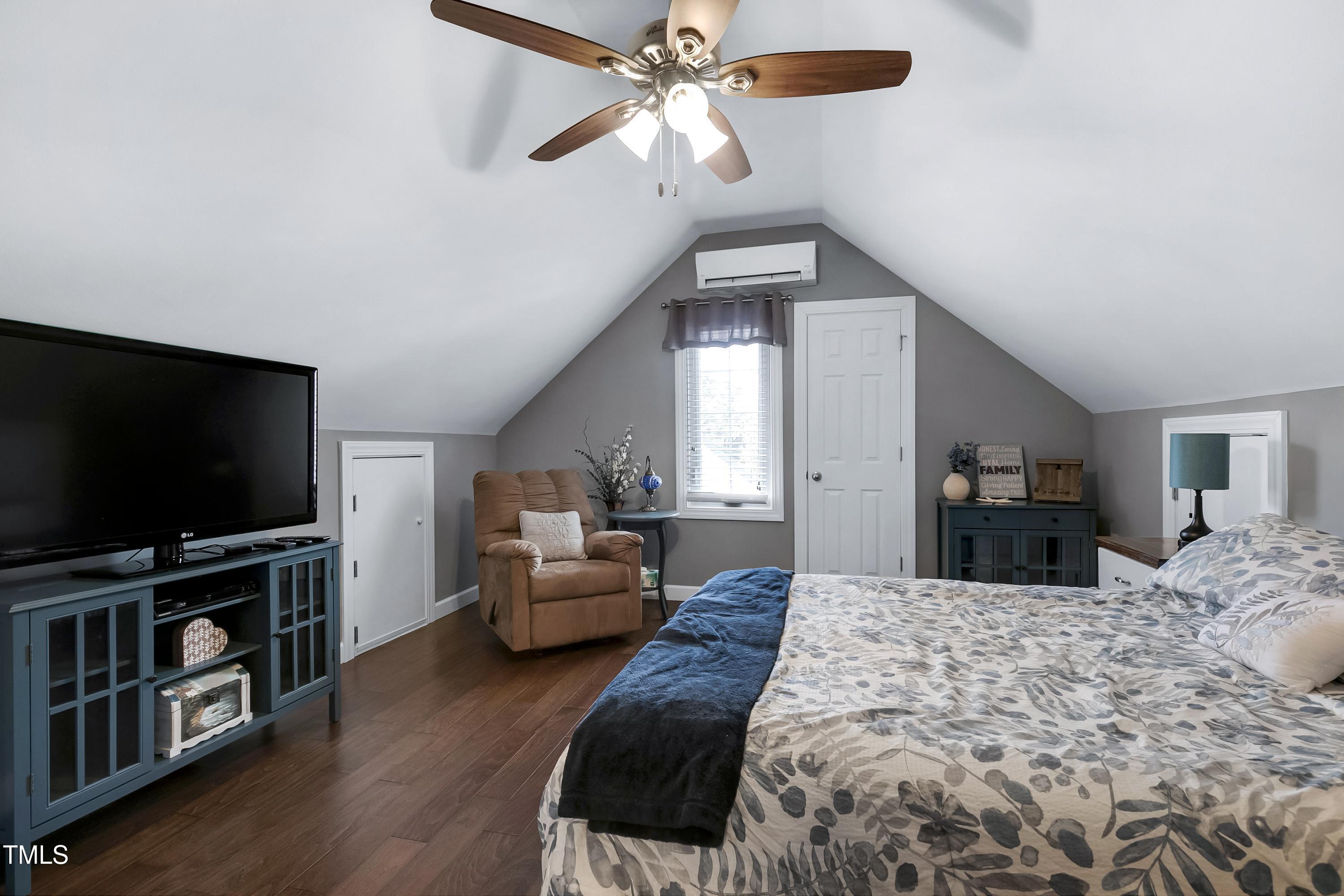 102 Kenneil Court Apex, NC 27502 - Photo 30 of 55 a bedroom with a bed and a flat screen tv