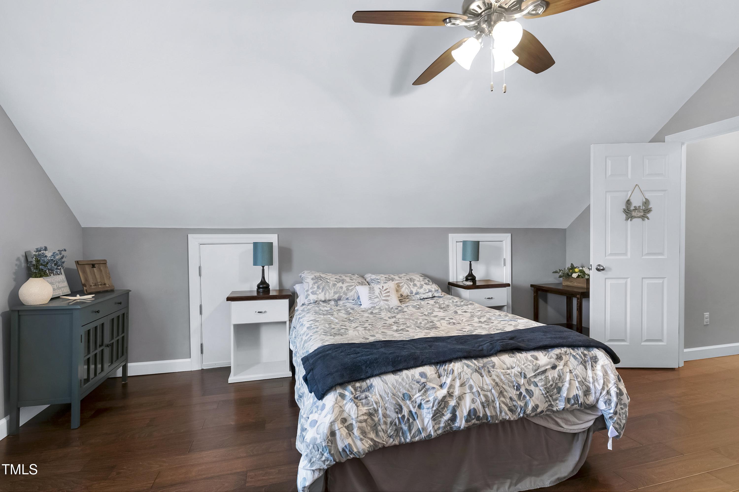 102 Kenneil Court Apex, NC 27502 - Photo 31 of 55 a bedroom with a bed and wooden floor