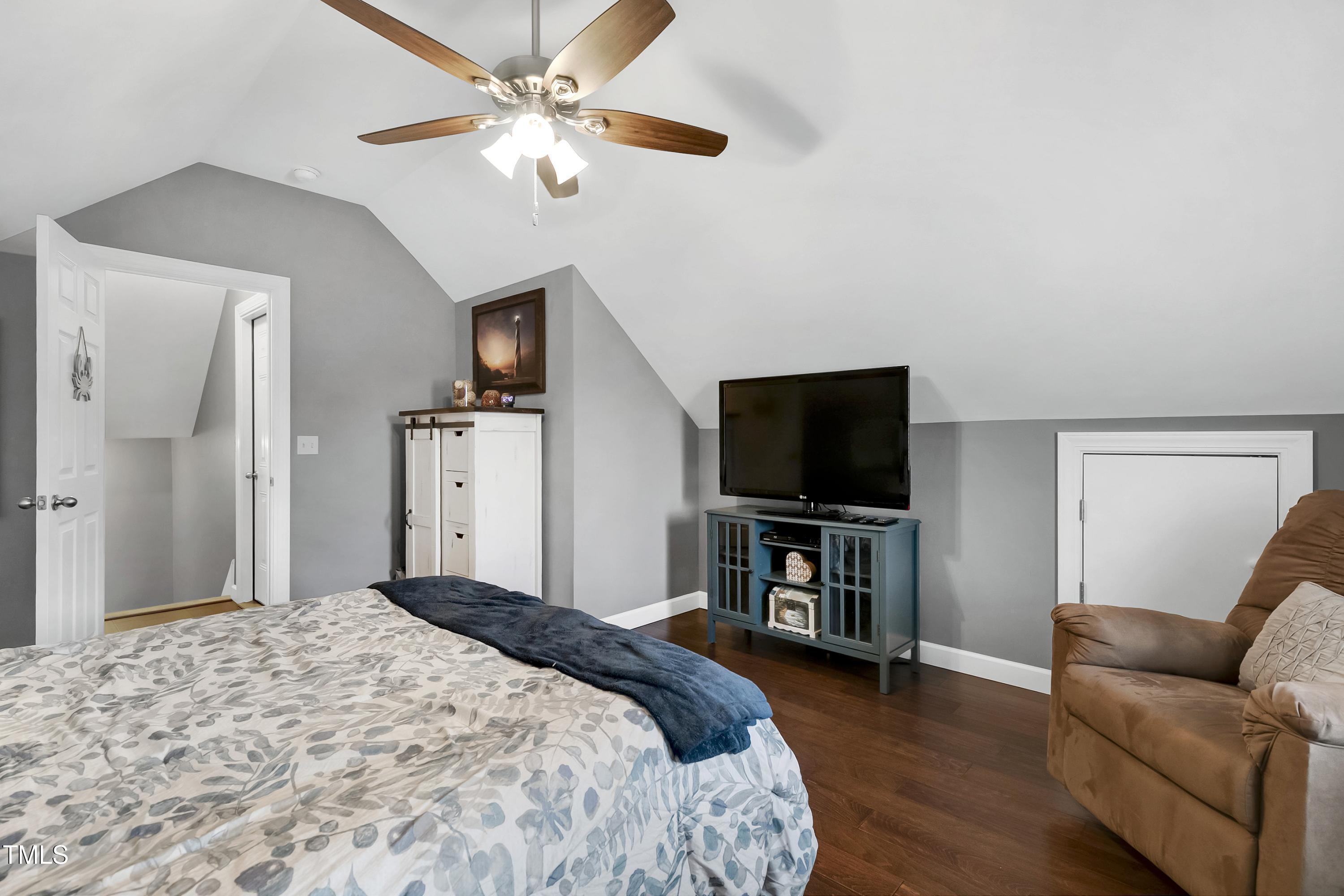 102 Kenneil Court Apex, NC 27502 - Photo 32 of 55 a bedroom with bed and a flat screen tv