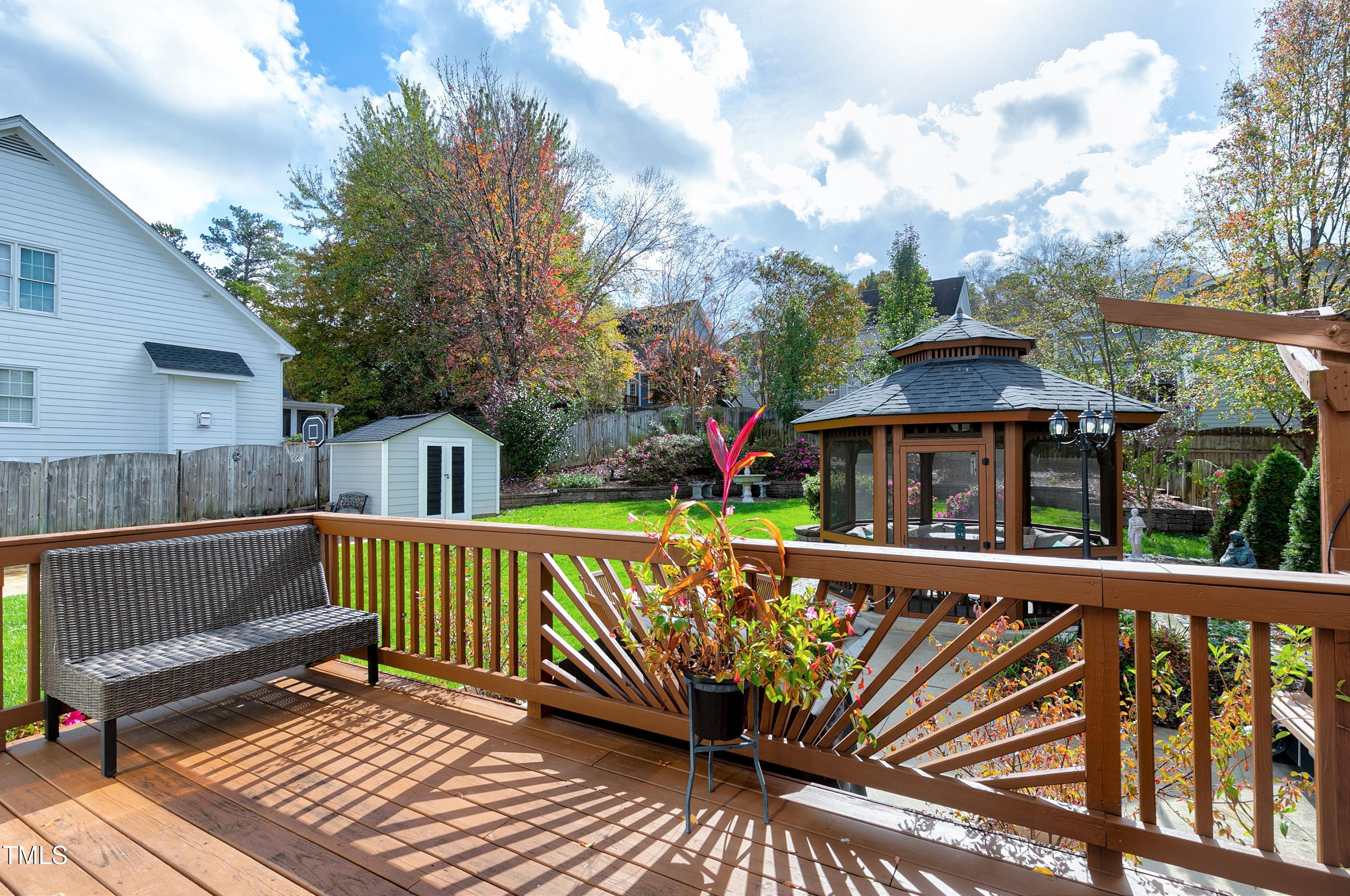 102 Kenneil Court Apex, NC 27502 - Photo 35 of 55 a view of a wooden deck with a bench