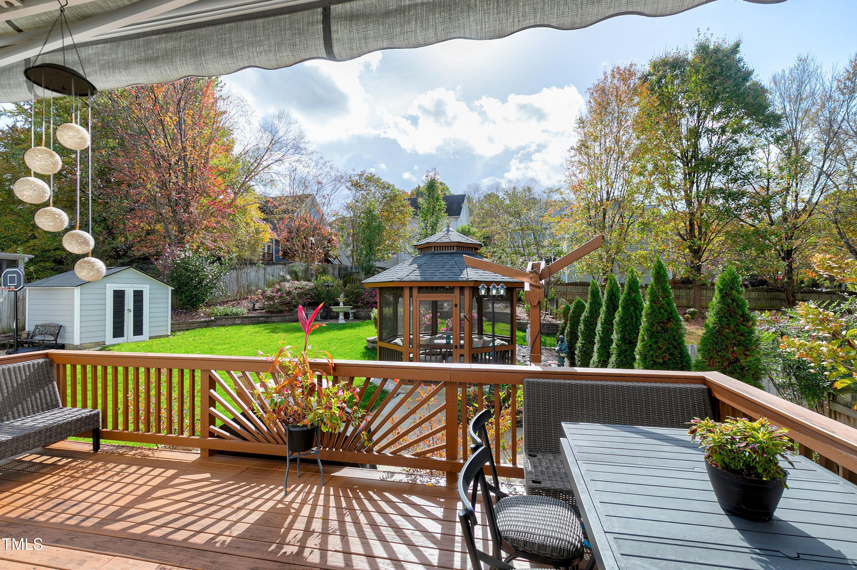 102 Kenneil Court Apex, NC 27502 - Photo 36 of 55 a view of a roof deck with table & chairs wooden floor and fence