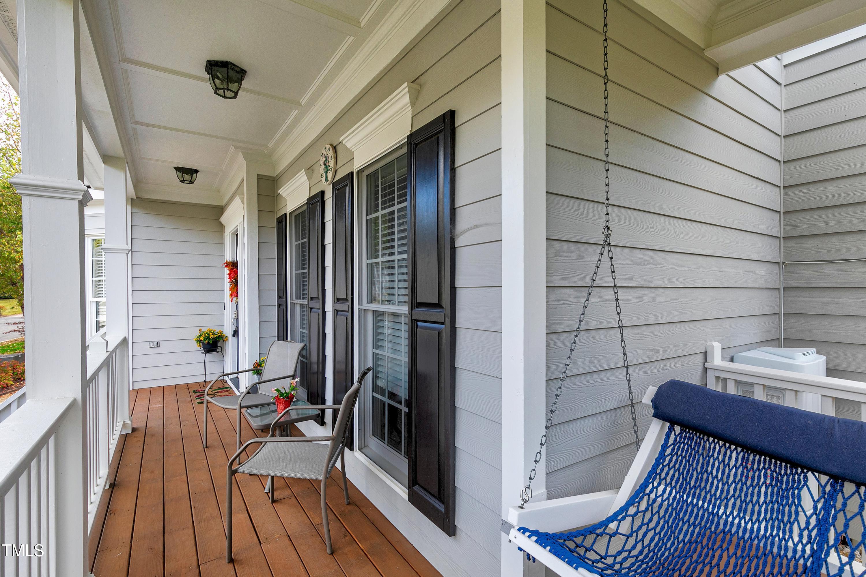 102 Kenneil Court Apex, NC 27502 - Photo 4 of 55 a view of a balcony with chairs and wooden floor