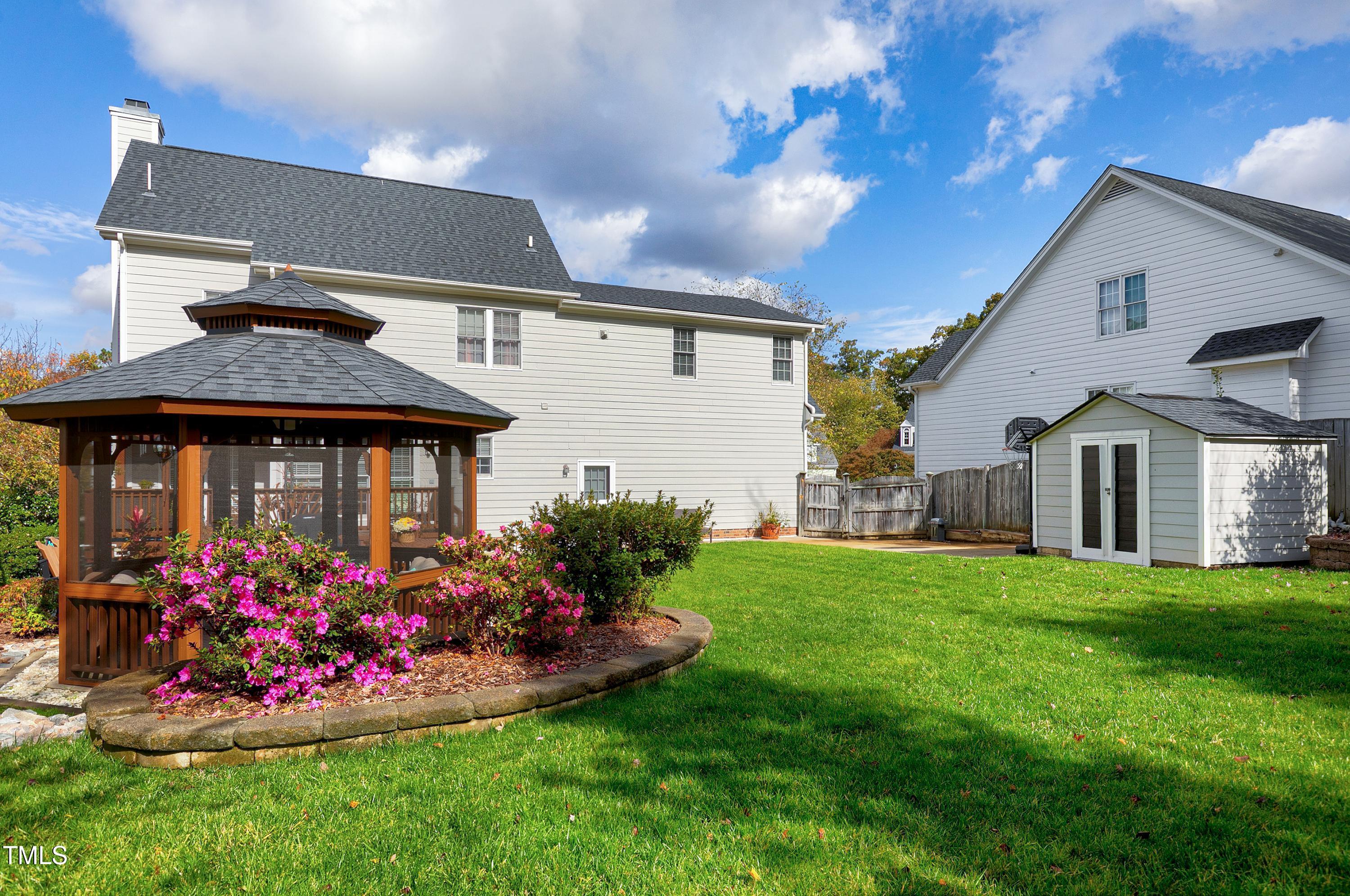 102 Kenneil Court Apex, NC 27502 - Photo 44 of 55 a front view of a house with a yard and potted plants