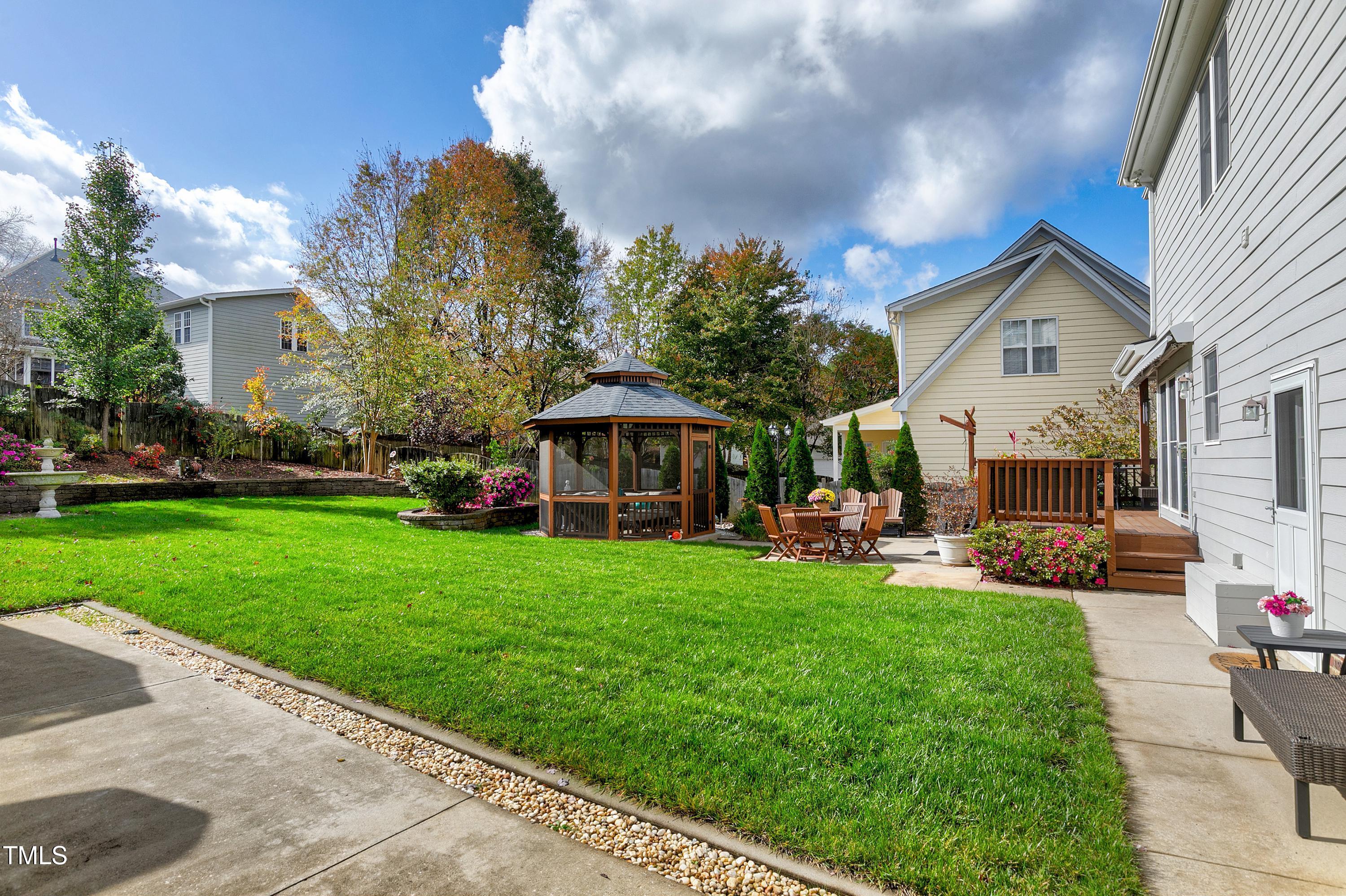 102 Kenneil Court Apex, NC 27502 - Photo 46 of 55 a front view of a house with a garden and trees