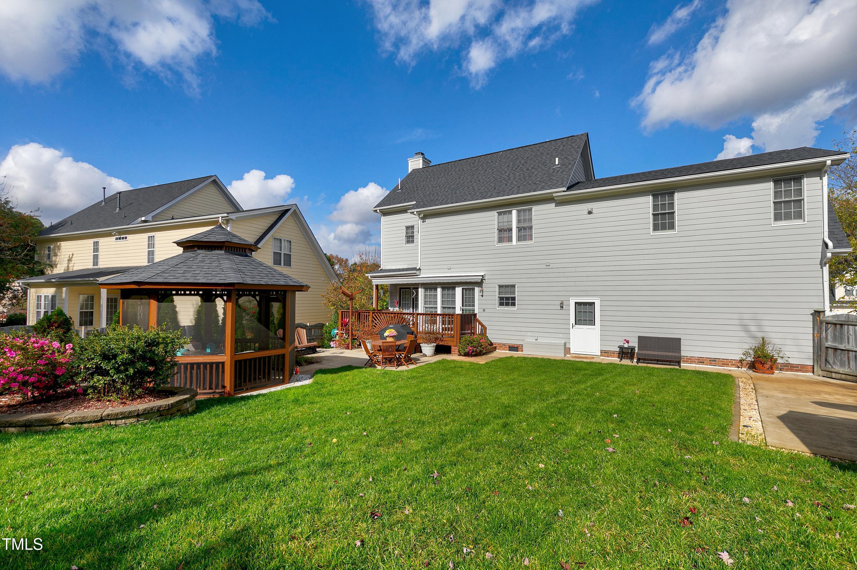 102 Kenneil Court Apex, NC 27502 - Photo 47 of 55 a view of a house with a backyard porch and sitting area