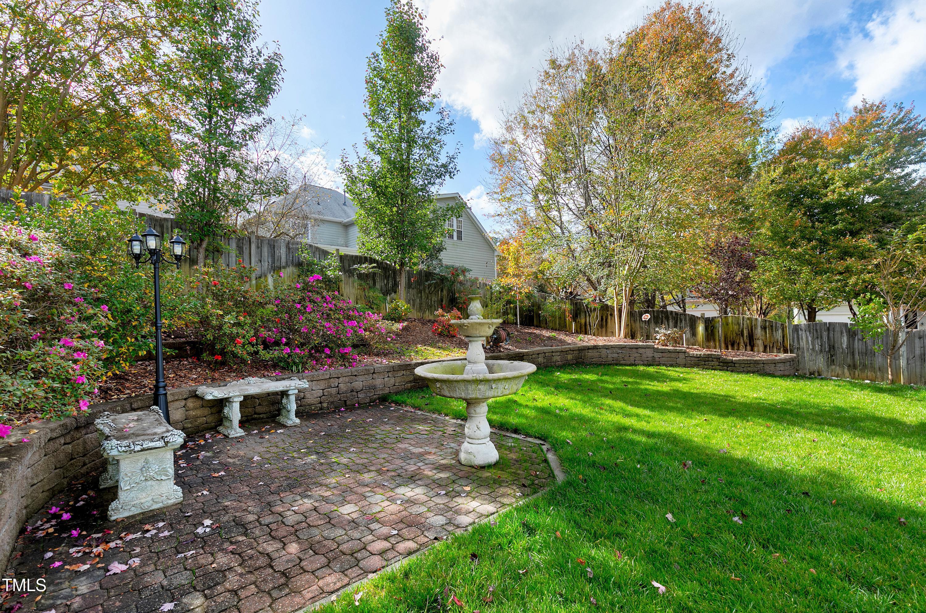 102 Kenneil Court Apex, NC 27502 - Photo 49 of 55 a view of a garden with sitting area