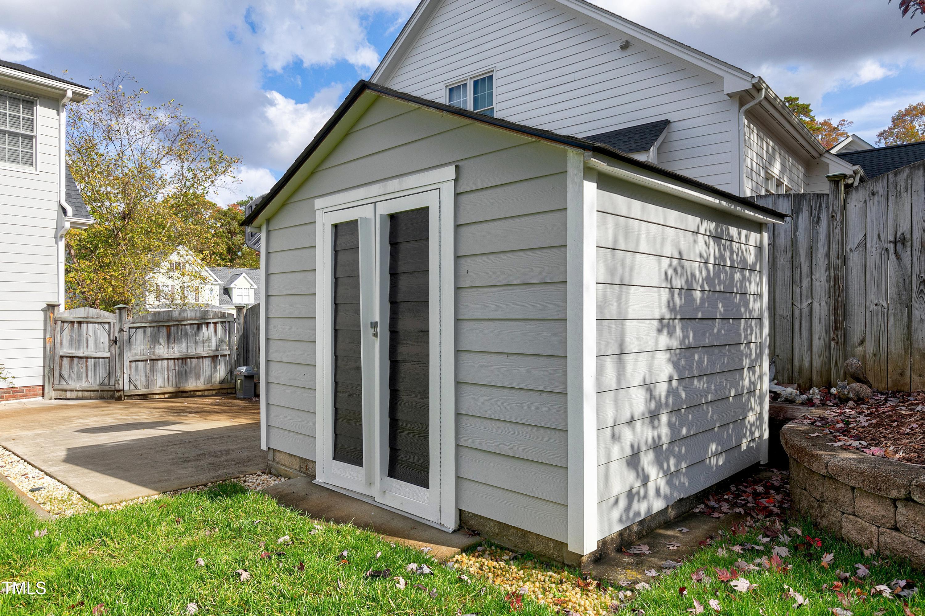 102 Kenneil Court Apex, NC 27502 - Photo 51 of 55 a view of a porch with a table and chairs and wooden fence
