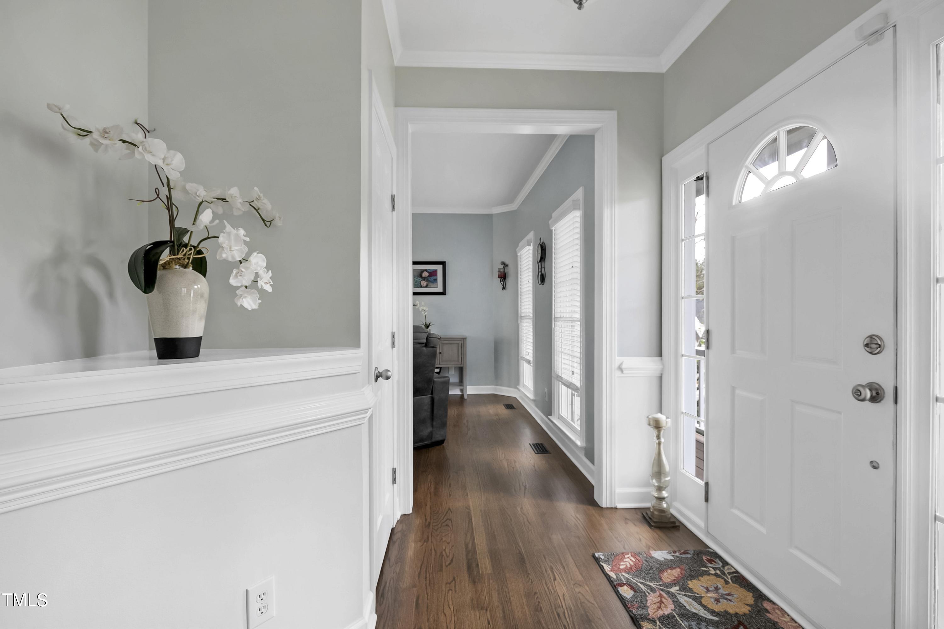 102 Kenneil Court Apex, NC 27502 - Photo 7 of 55 a view of a hallway view with wooden floor and staircase