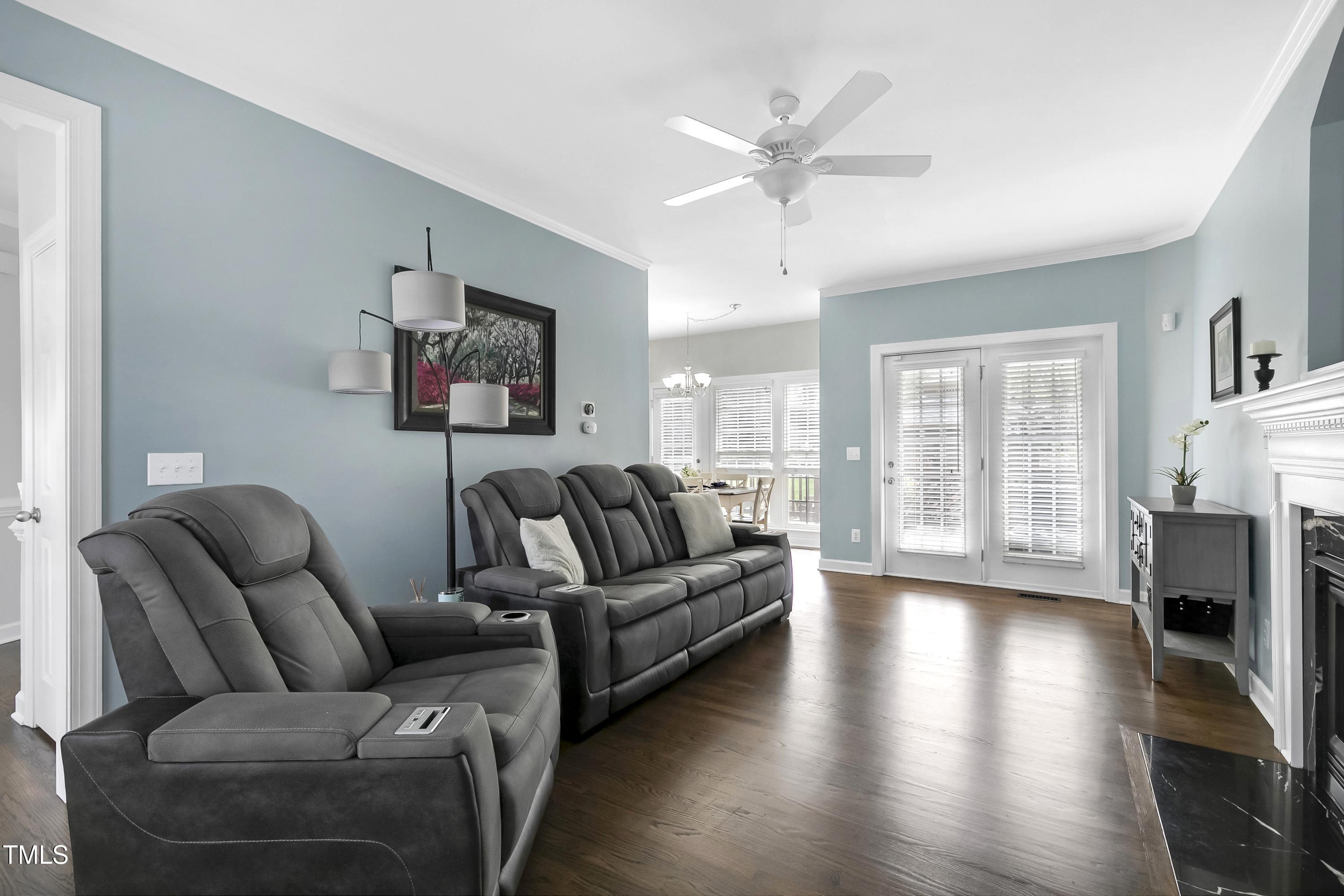 102 Kenneil Court Apex, NC 27502 - Photo 8 of 55 a living room with furniture a large window and a fireplace