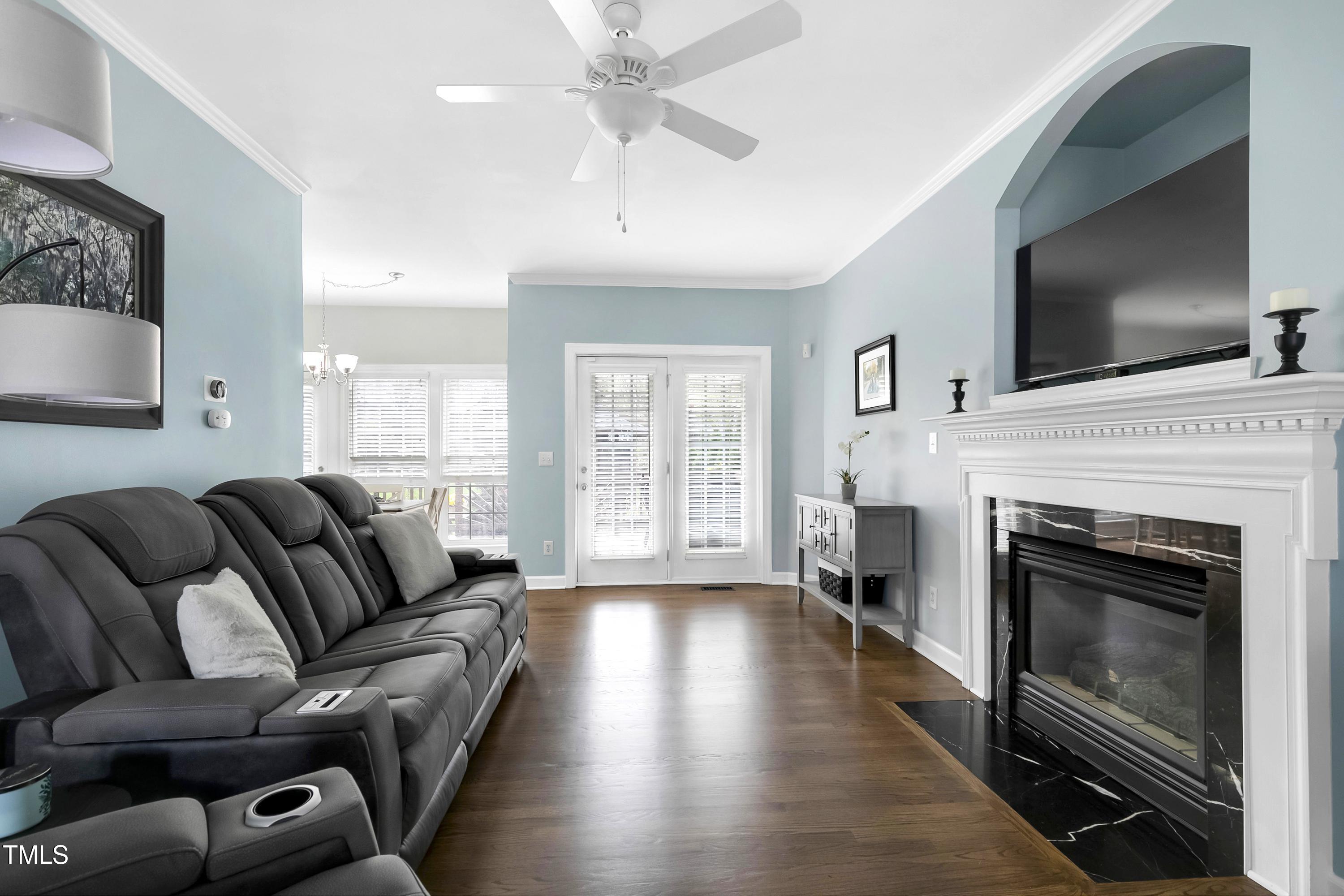 102 Kenneil Court Apex, NC 27502 - Photo 9 of 55 a living room with furniture a flat screen tv and a fireplace