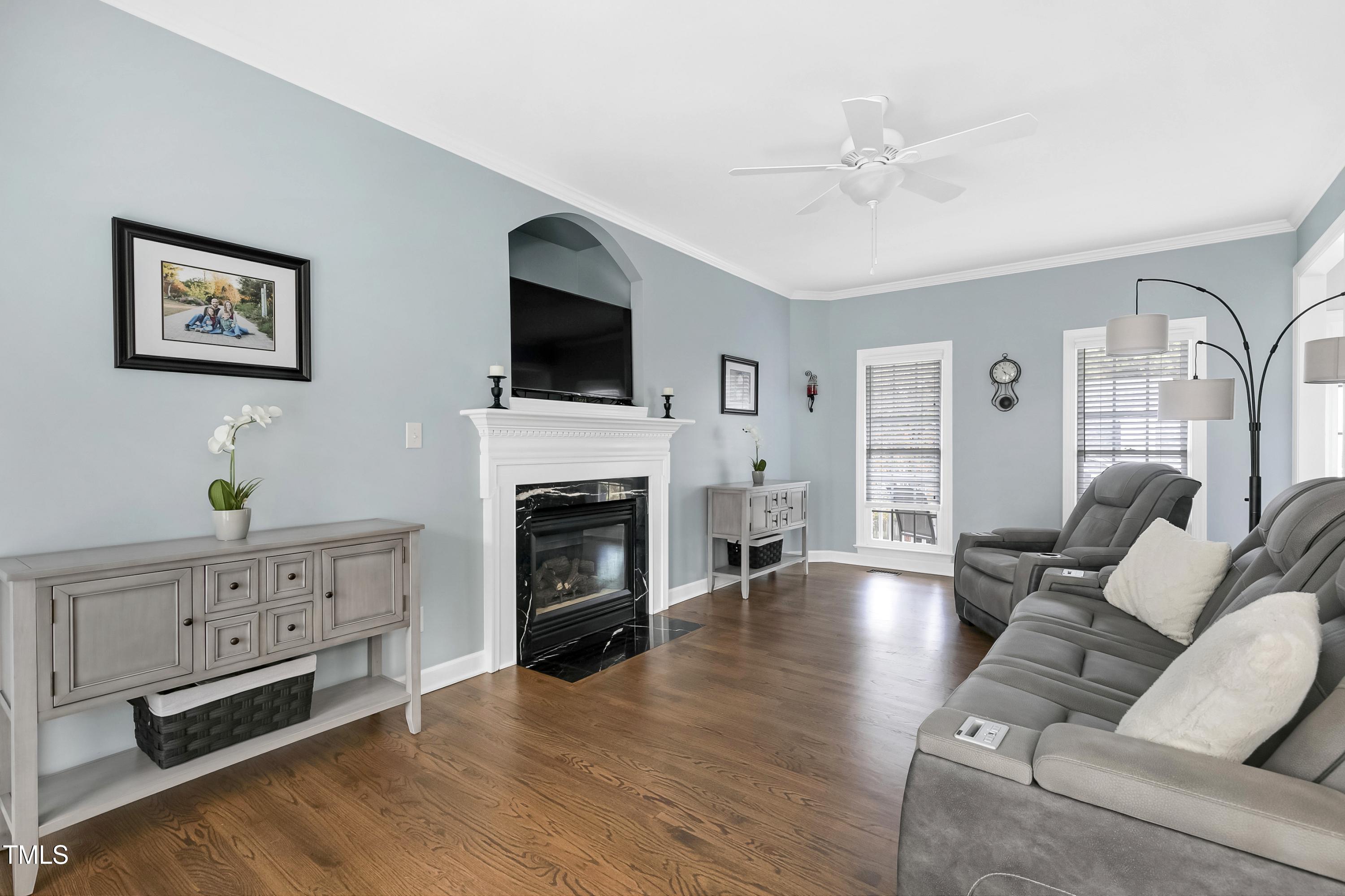 102 Kenneil Court Apex, NC 27502 - Photo 10 of 55 a living room with furniture a fireplace and a flat screen tv