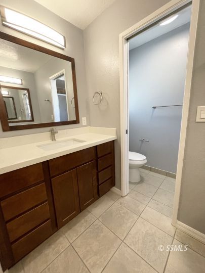 656 West Felspar Avenue Ridgecrest, CA 93555 - Photo 34 of 45 a spacious bathroom with a toilet sink and mirror