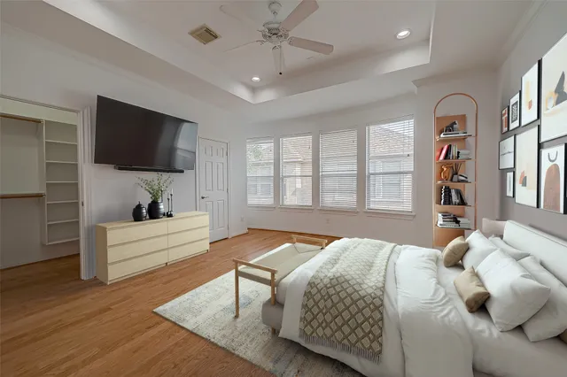 a bedroom with a large bed and a flat screen tv
