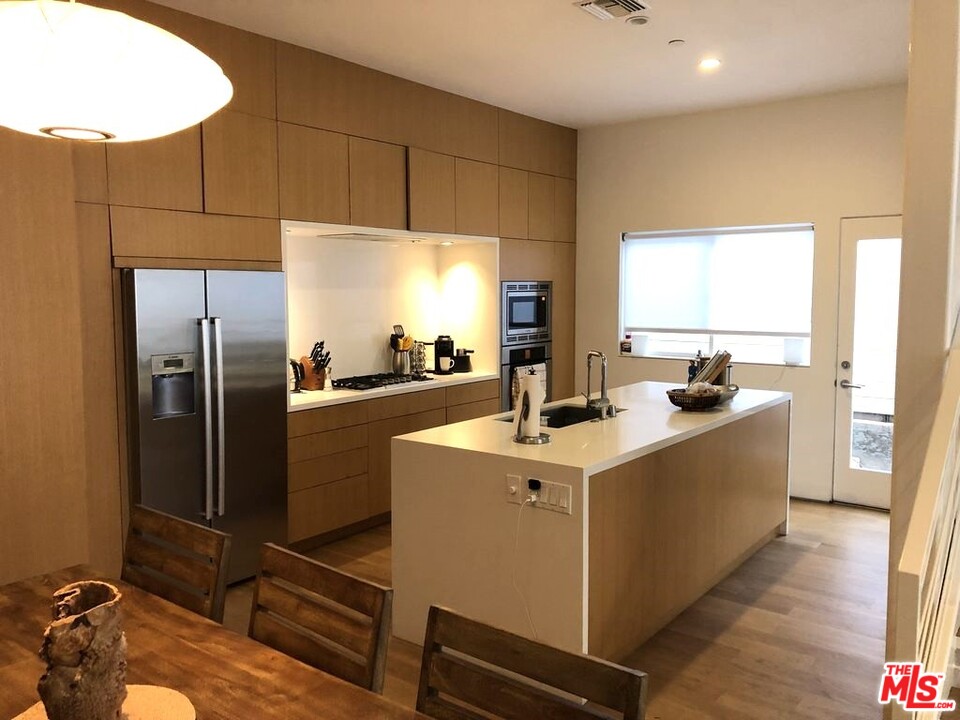 338 Rennie Avenue, Unit 2 Venice, CA 90291 - Photo 3 of 21 a kitchen with stainless steel appliances a sink a stove a refrigerator and cabinets