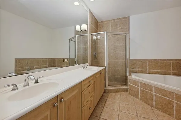 a bathroom with a granite countertop sink a toilet a glass door shower and a mirror