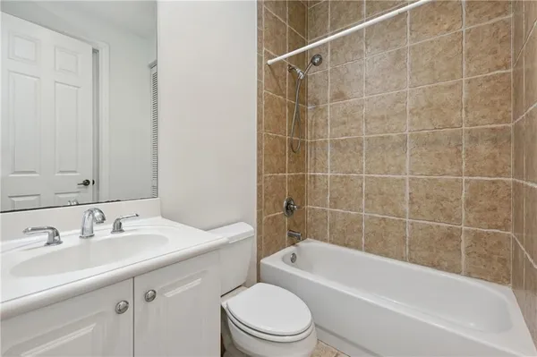 a bathroom with a sink mirror toilet and bathtub