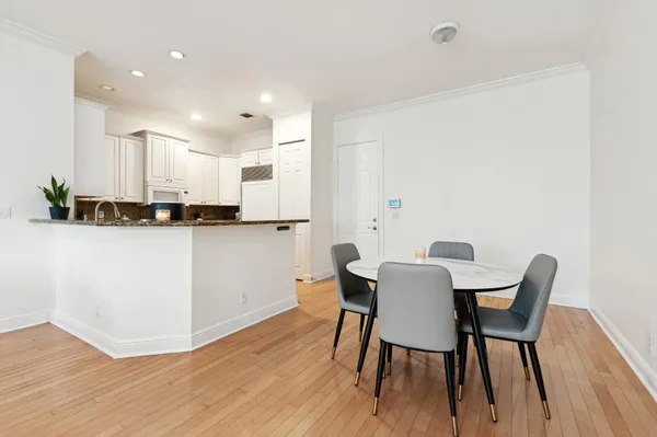 a dining room with furniture and wooden floor