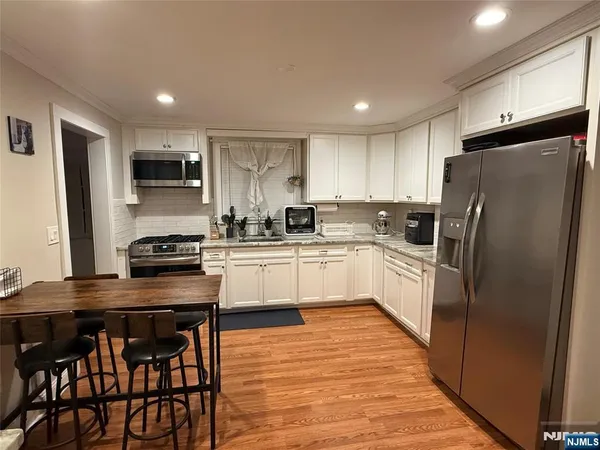 a kitchen with stainless steel appliances a refrigerator stove microwave and cabinets