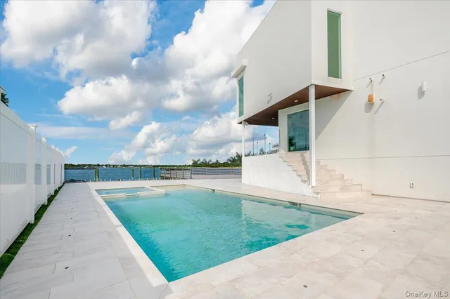 a view of a swimming pool and an outdoor seating