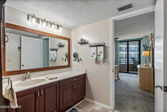 a bathroom with a sink a toilet and mirror