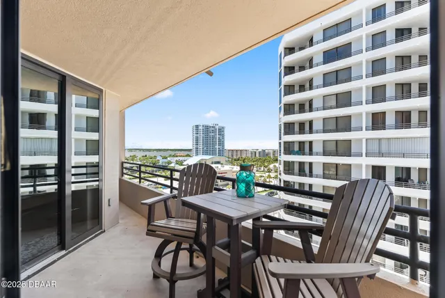 a view of a city from a dining room with furniture