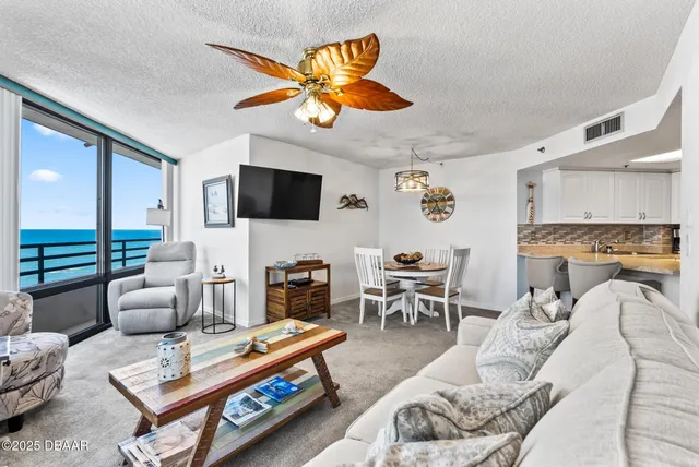 a living room with furniture a rug and a flat screen tv
