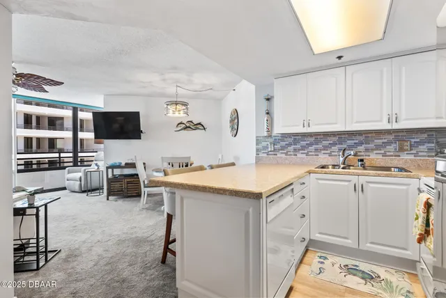 a kitchen with granite countertop a sink stove and cabinets