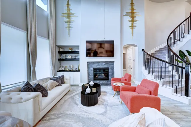 a living room with furniture fireplace and flat screen tv