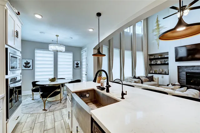 a kitchen with stainless steel appliances granite countertop a sink a stove a refrigerator and cabinets