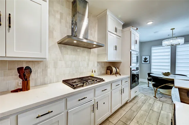 a kitchen with a stove a sink and a refrigerator