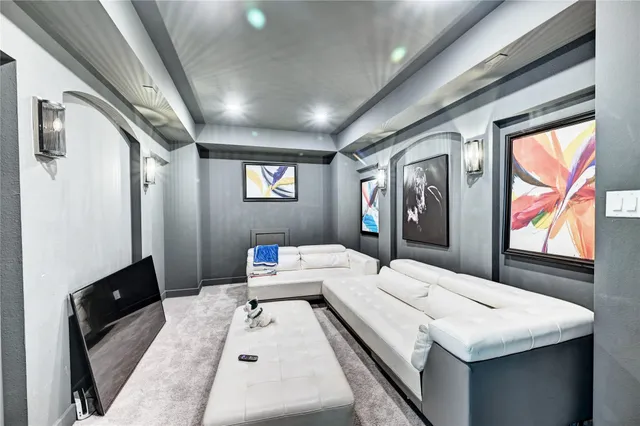 a room with furniture a flat screen tv and a window