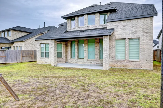 a view of a house with a small yard and swimming pool