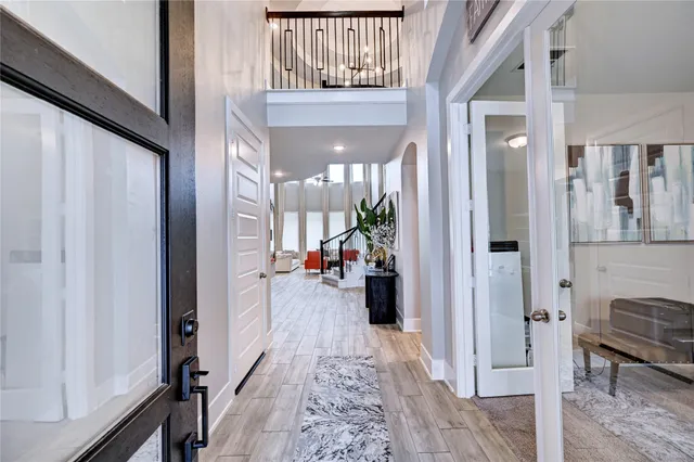 a view of a hallway with furniture and floor to ceiling window