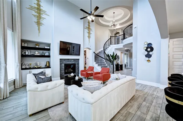 a dining room with wooden floor a chandelier a wooden table and chairs