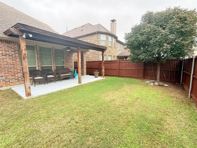 a view of a house with a yard and sitting area