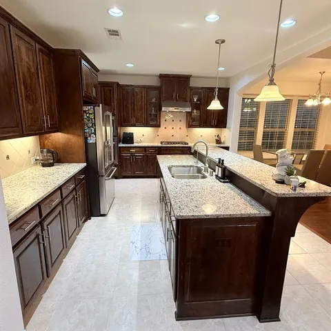 a view of a room with a ceiling fan and a window