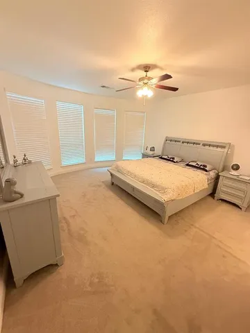 a bedroom with a bed and cabinets