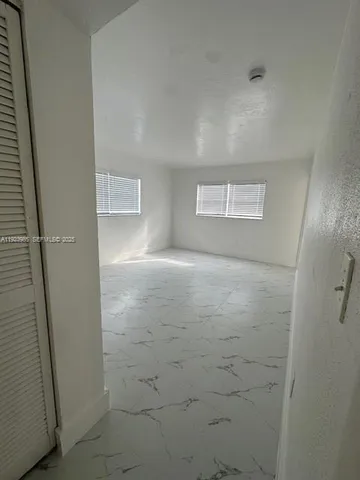 a view of hallway with an empty room