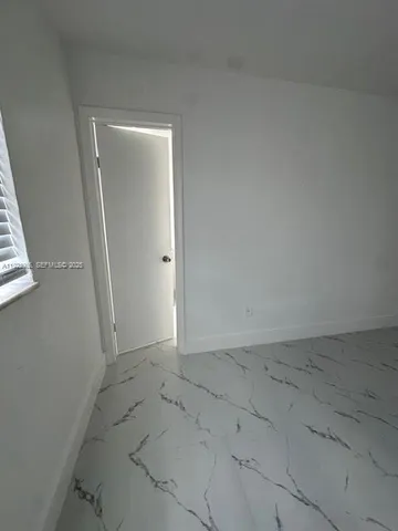 an empty room with a bench