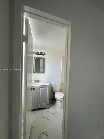 a bathroom with a sink a toilet and mirror