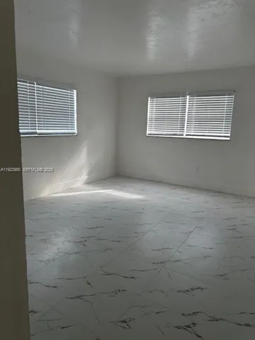 a view of empty room with windows