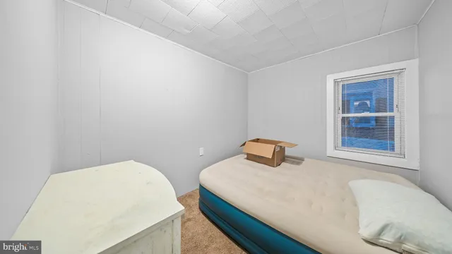 a bedroom with a bed and window