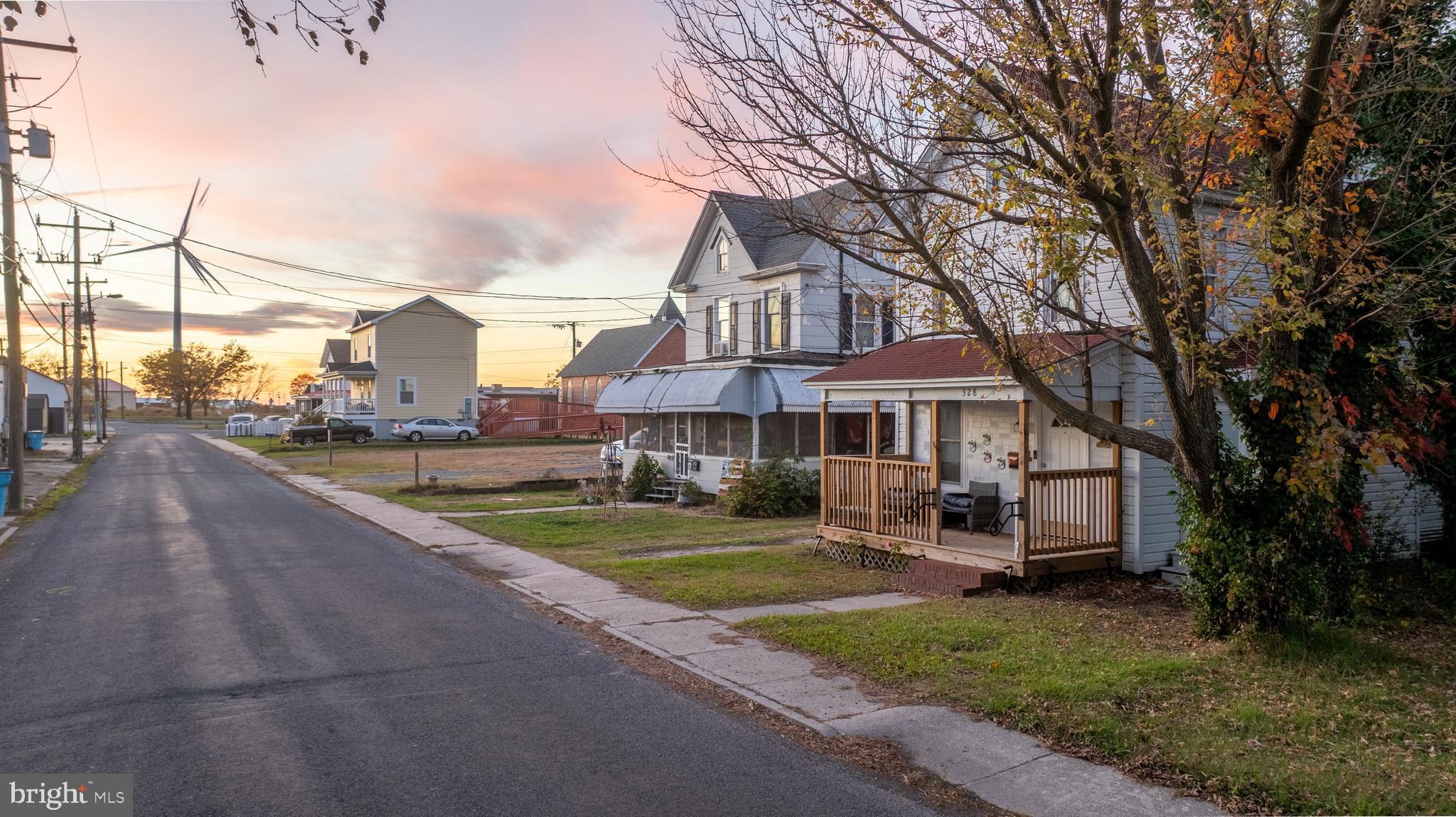 328 Pine Street Crisfield, MD 21817 - Photo 2 of 23 a front view of a house with yard porch and tree