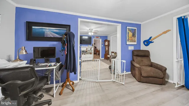 a view of a livingroom with workspace and a couch