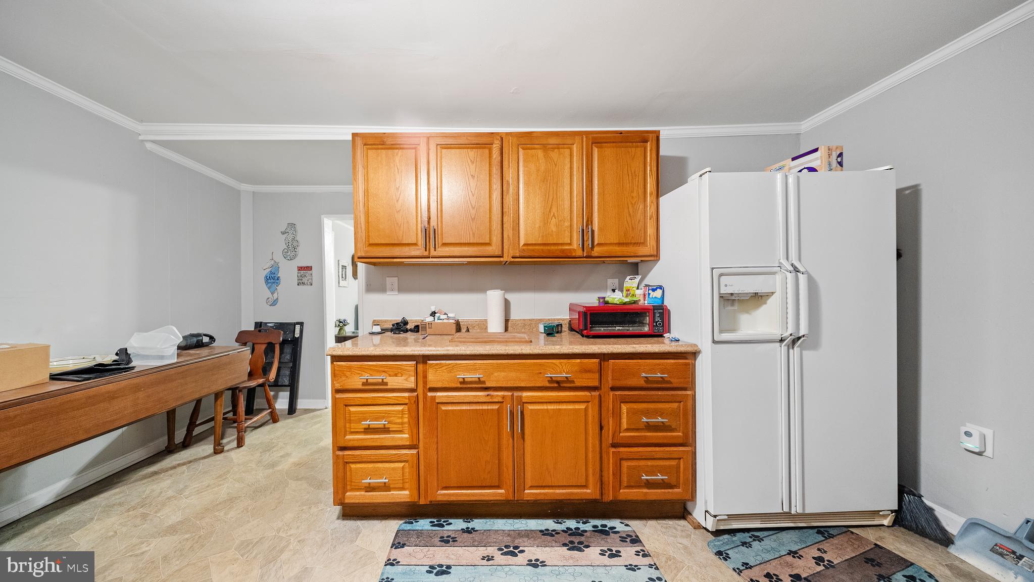 328 Pine Street Crisfield, MD 21817 - Photo 7 of 23 a kitchen with stainless steel appliances granite countertop a refrigerator and a stove top oven