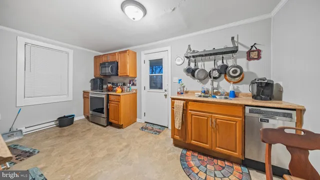 a kitchen with stainless steel appliances granite countertop a sink stove and cabinets