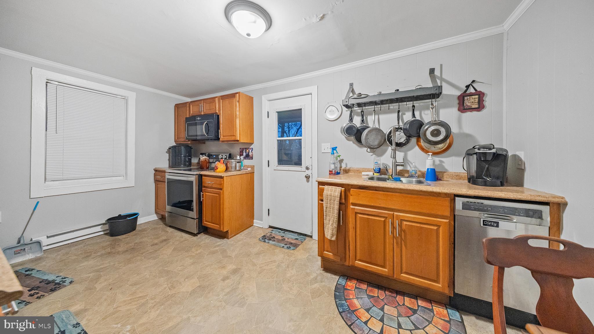 328 Pine Street Crisfield, MD 21817 - Photo 9 of 23 a kitchen with stainless steel appliances granite countertop a sink stove and cabinets