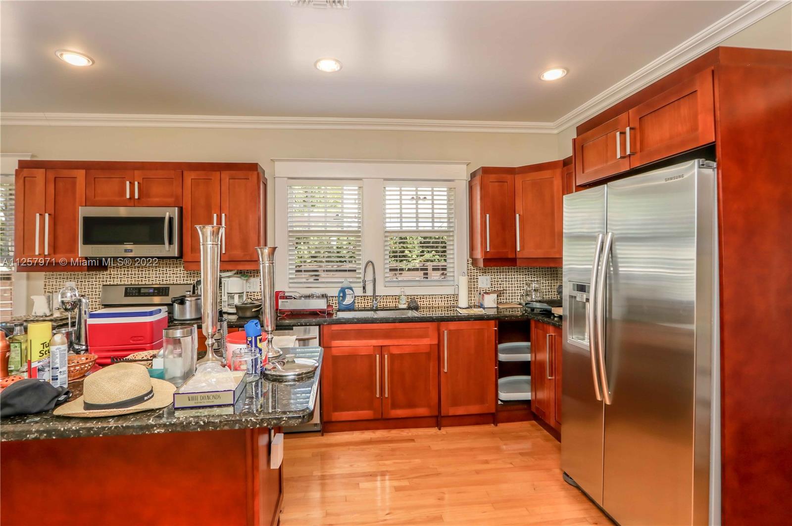 226 Southwest 21st Road Miami, FL 33129 - Photo 22 of 31 a kitchen with stainless steel appliances granite countertop a refrigerator and a stove top oven